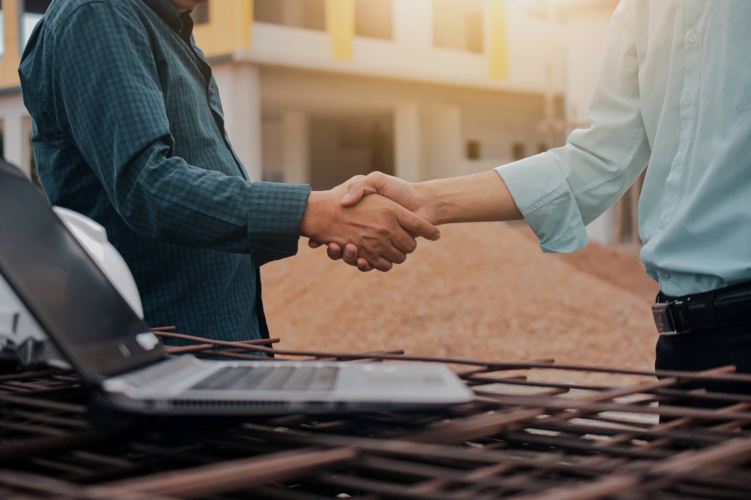 Business Partners Shake Hands in Construction Site 